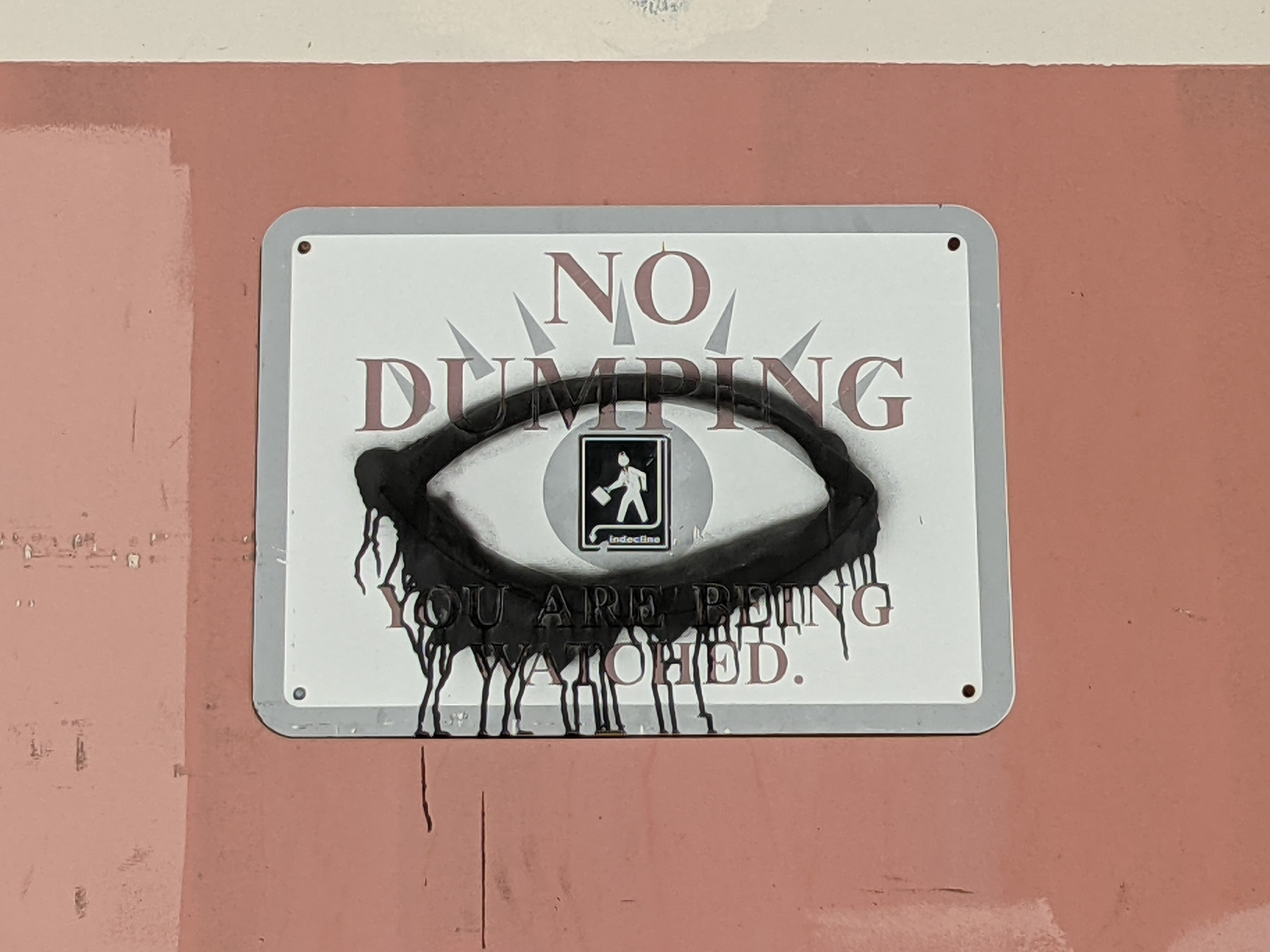 graffiti eye over 'you are being watched' sign